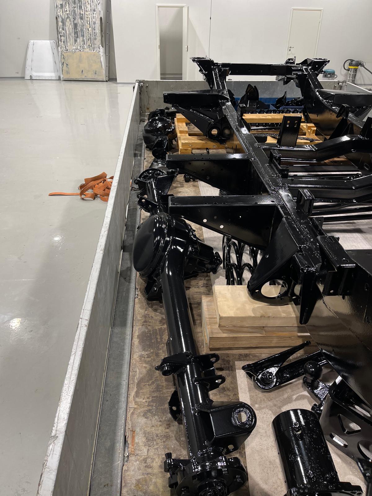 Stripped & refurbished chassis — gloss black, axles & control arms