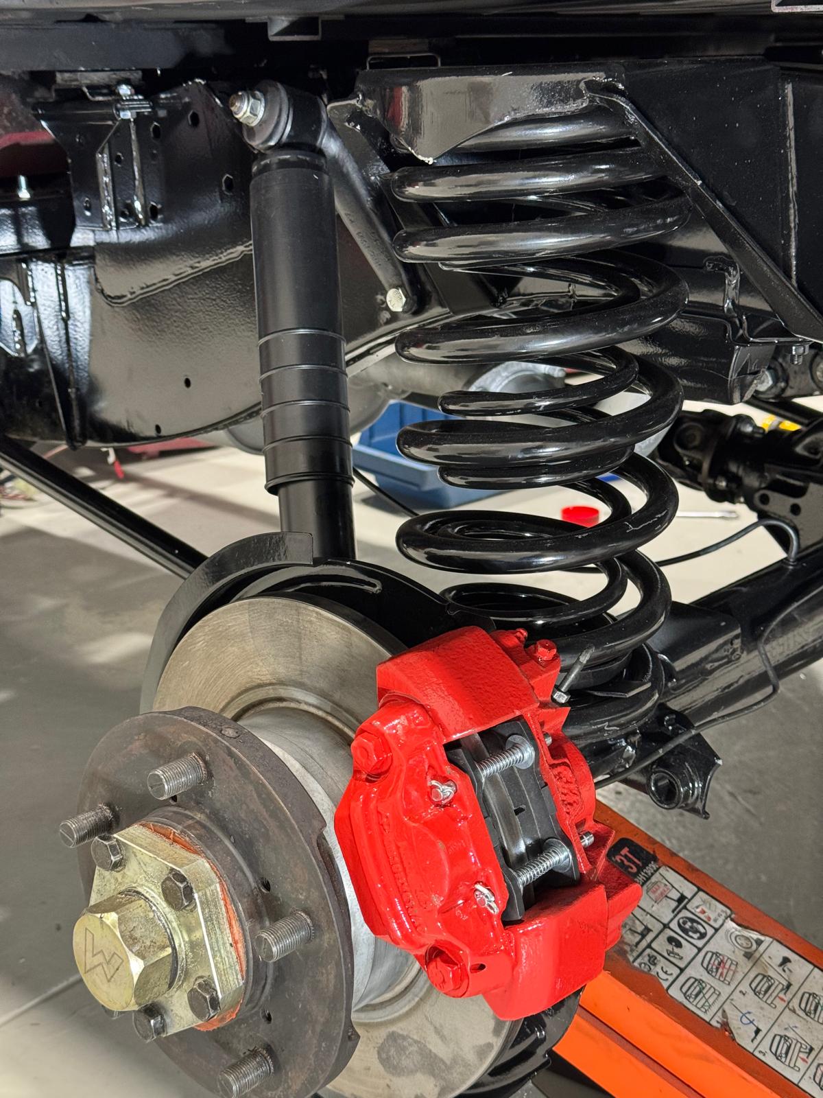 Suspension assembly — coil spring, damper, red caliper